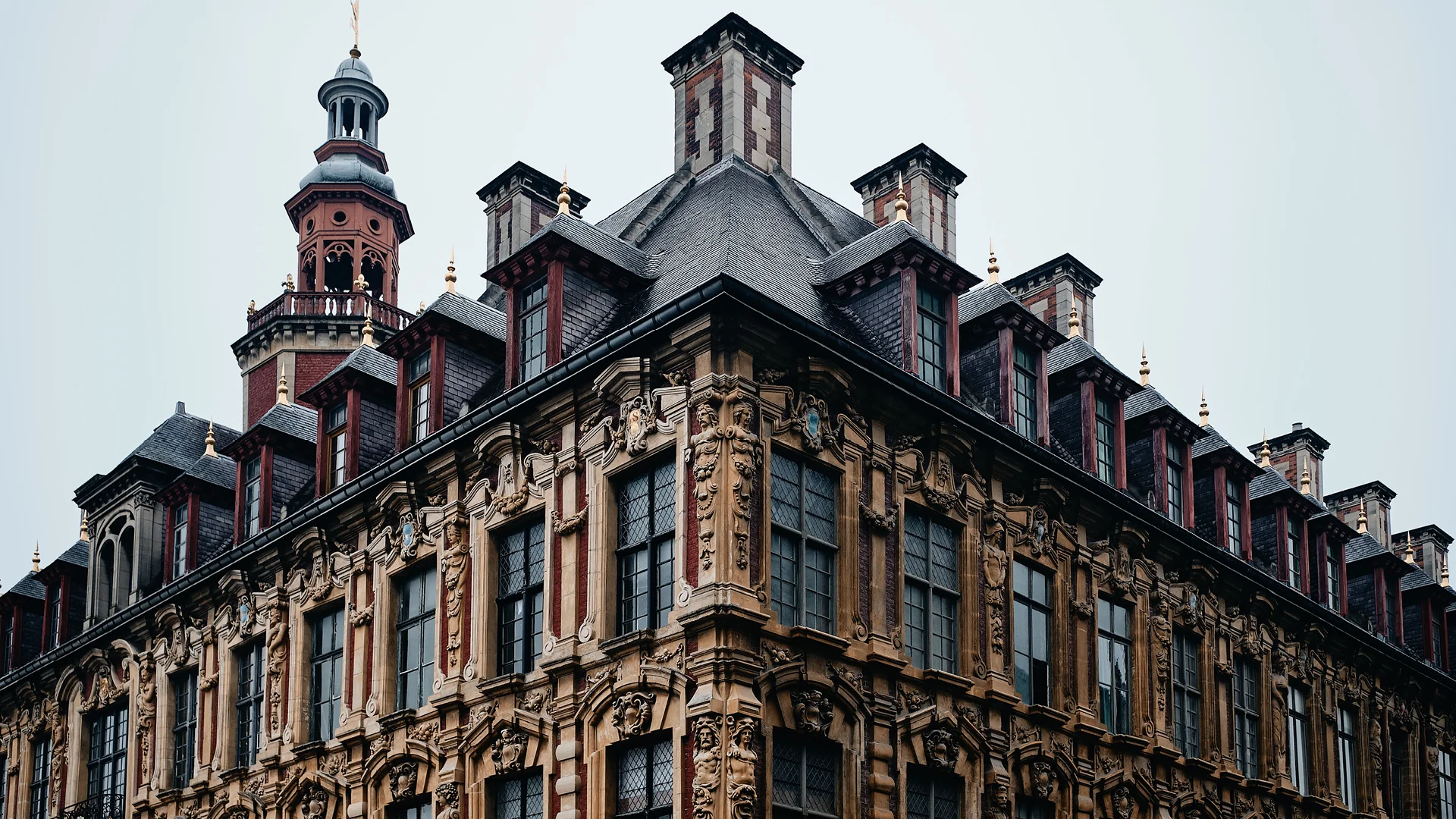 Ornate historic building with a tower, typical of Northern European or German architecture. The image suggests a real estate project involving the conversion of the property for premium hospitality use.